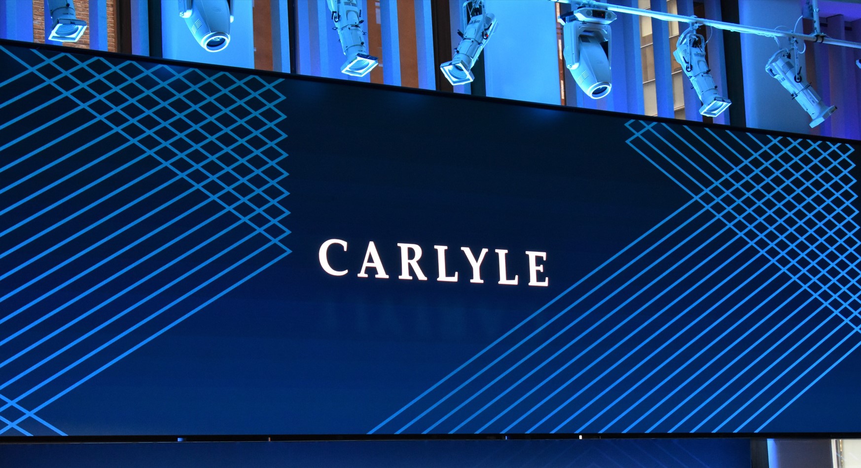 Carlyle logo displayed on a video screen